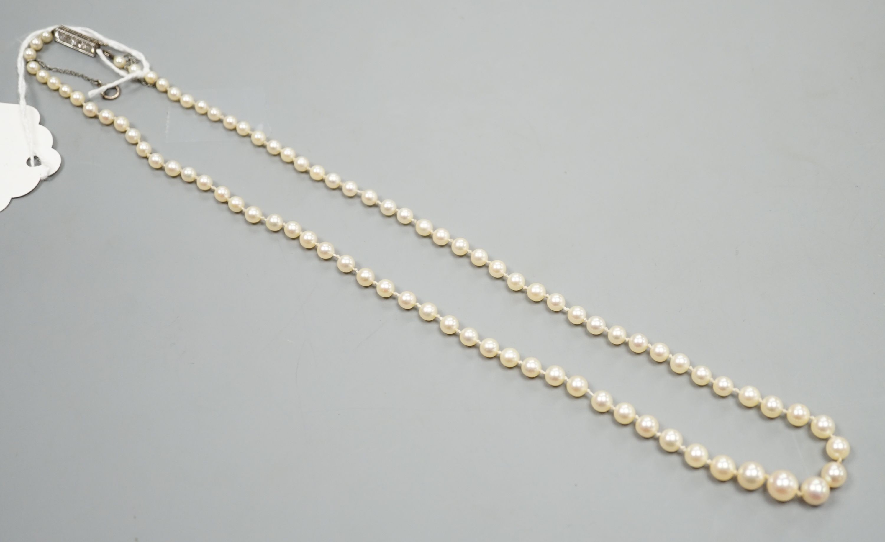 A single strand graduated cultured pearl necklace, with four stone diamond set white metal clasp, 50cm, gross weight 14.4 grams (pearls have not been tested), together with a gentleman's stainless steel Spearhead manual